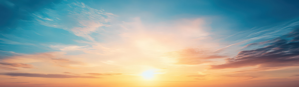 Vibrant sunrise over the skyline with soft clouds and a clear sky